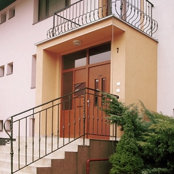 Forged balcony and staircase railing at a house entrance – exterior railings Forged balcony and staircase railing at a house entrance – exterior railings