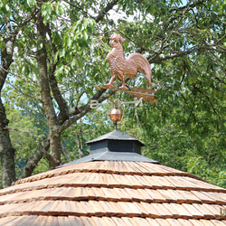 Copper rooster on a forged roof – summer gazebo near the family house Copper rooster on a forged roof – summer gazebo near the family house