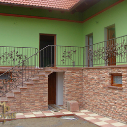 A wrought iron railing - an oak branch motif A wrought iron railing - an oak branch motif