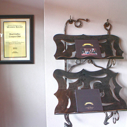 A wrought iron magazine rack A wrought iron magazine rack