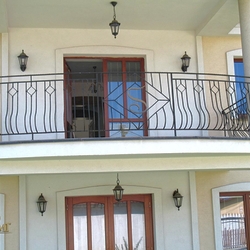A wrought iron railing with a logo A wrought iron railing with a logo