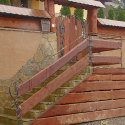 A wrought iron railing with wood A wrought iron railing with wood