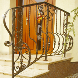 A wrought iron railing - house entrance A wrought iron railing - house entrance