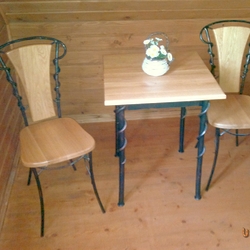 Forged table and chairs as part of the furniture in the room of the Šariš pension Forged table and chairs as part of the furniture in the room of the Šariš pension