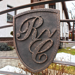 A wrought iron coat of arms - initials A wrought iron coat of arms - initials