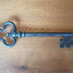A wrought iron key in green patina A wrought iron key in green patina