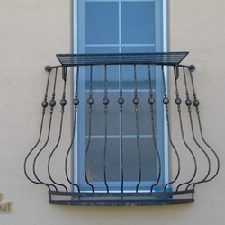 A wrought iron railing - a French window A wrought iron railing - a French window